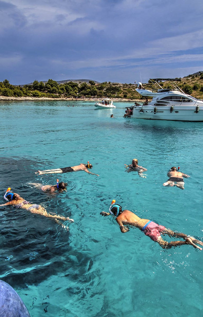 People swimming and snorkling on the Kornati Islands National Park in the Zadar Archipelago.