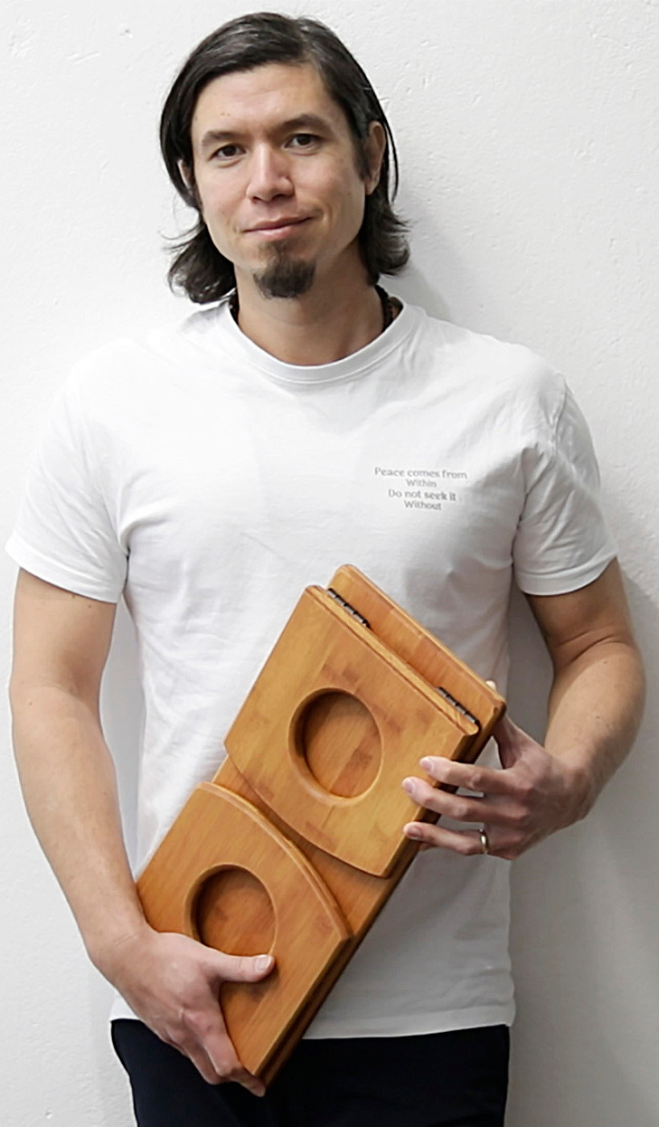 Teacher and founder Jeff holding a self-made meditation bench