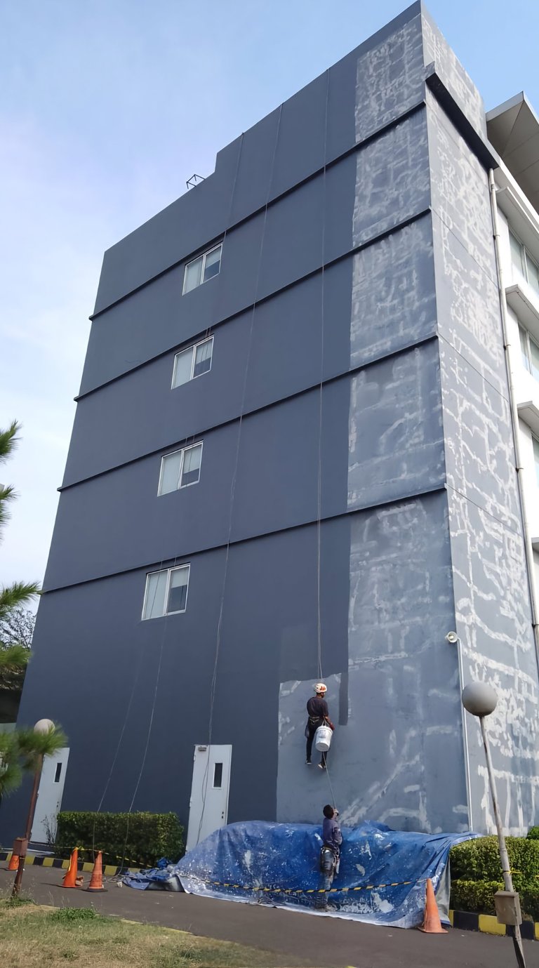 a man climbing up a building with a rope rope