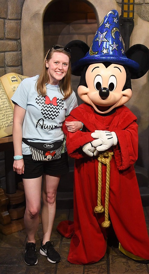 Aimee Cochrane pictured with Sorcerer Mickey at Disney's Hollywood Studios® inside Walt Disney World®.