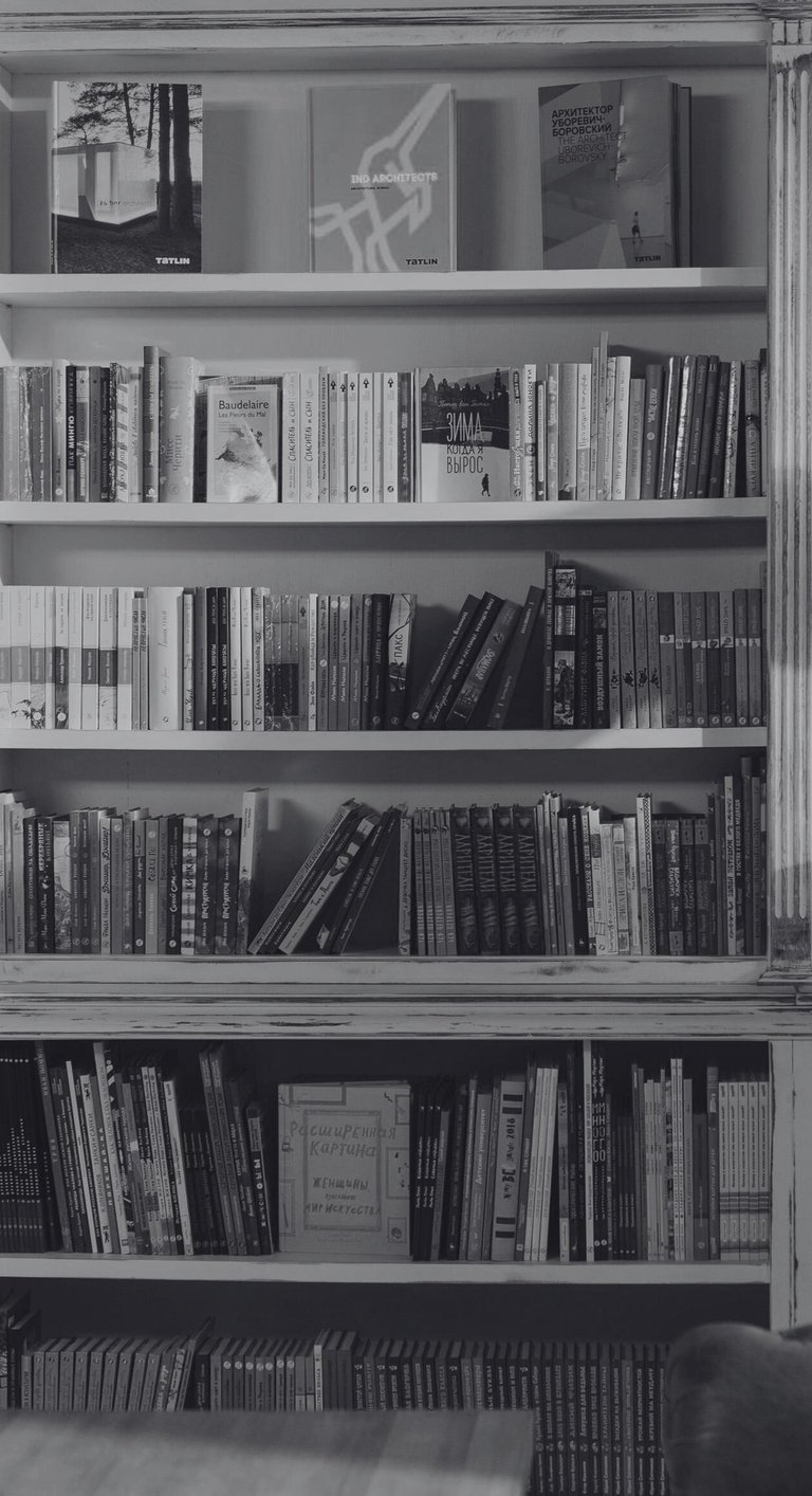 a single man and a single woman looking at books at a bookshop