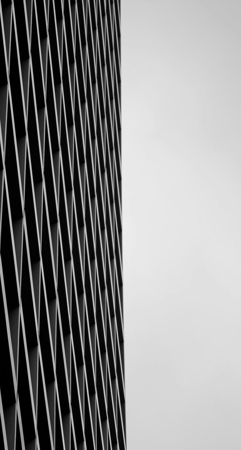 Modern architectural detail featuring a geometric mesh screen.