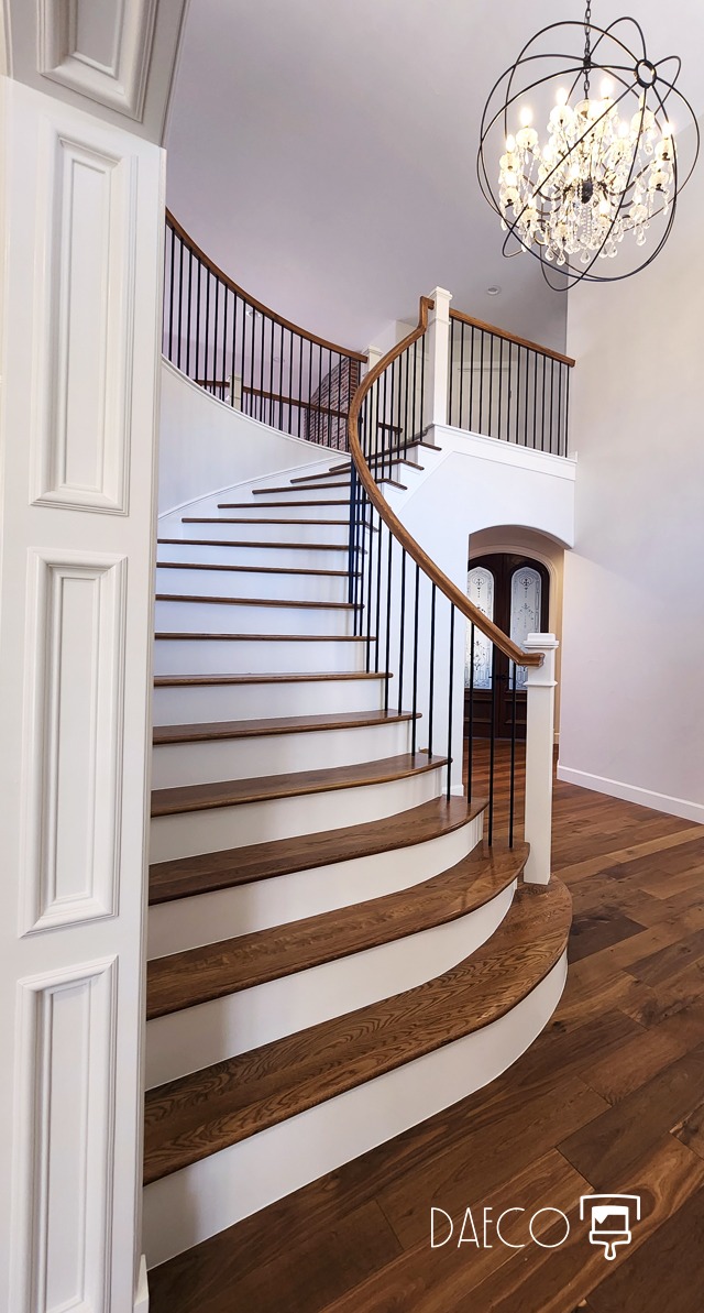a staircase leading to a foyer with a chandelier - Denver Luxury Home Painting