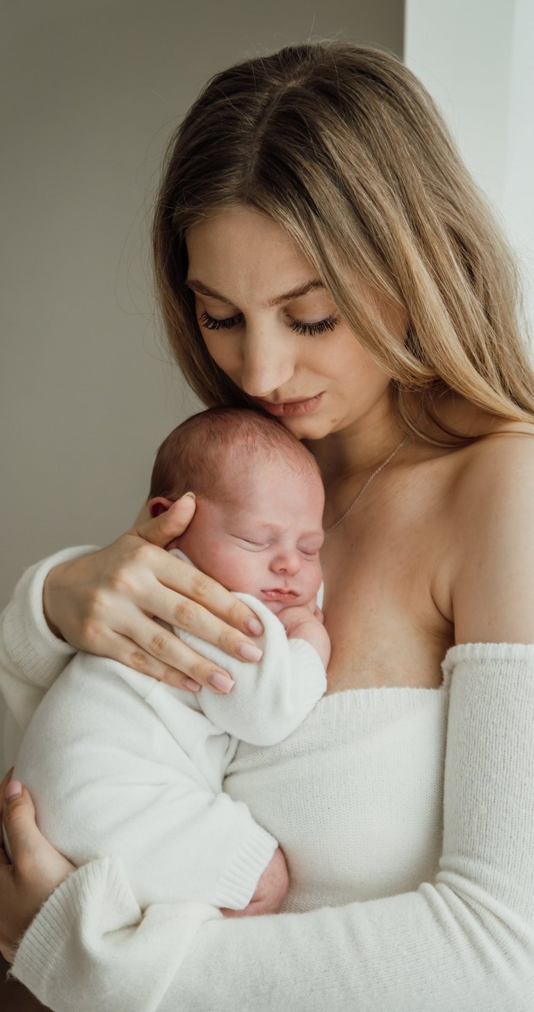 a woman holding a baby in her arms