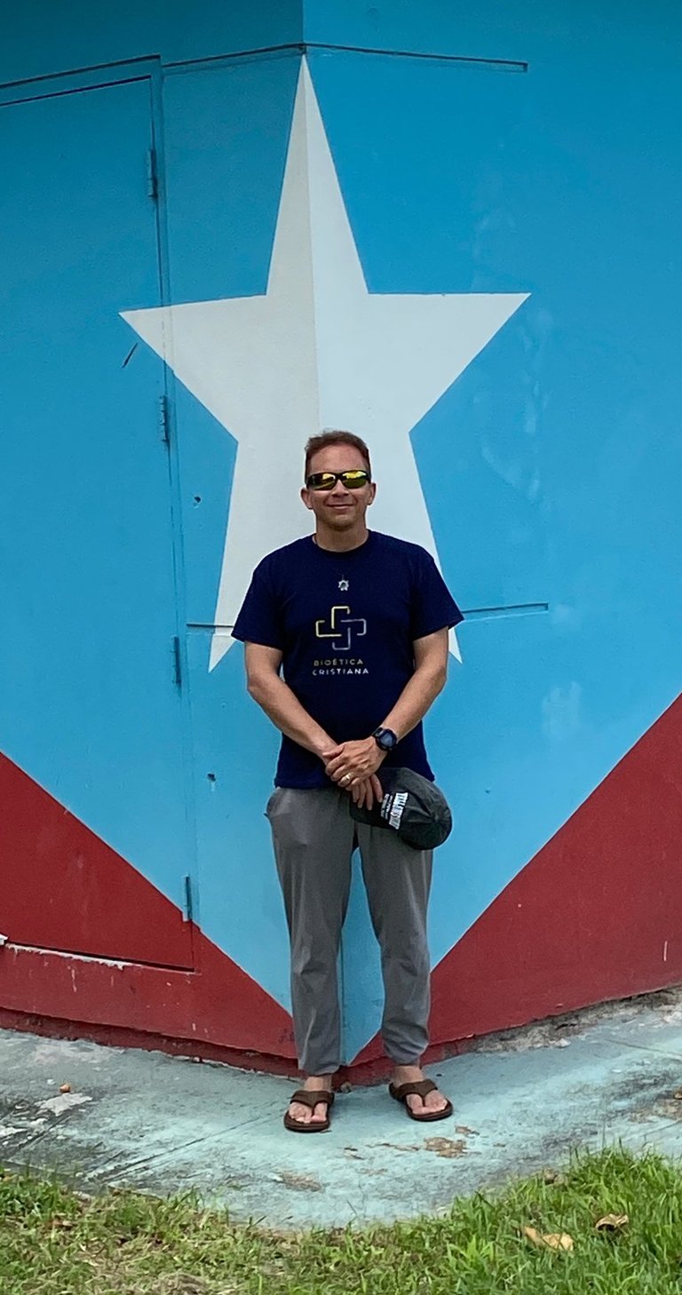 a man standing in front of a building with a large star on it