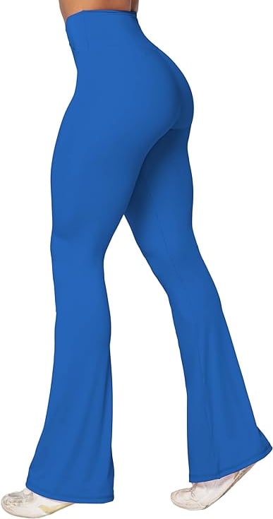 a woman in a blue pantsuit with a white top and white shoes