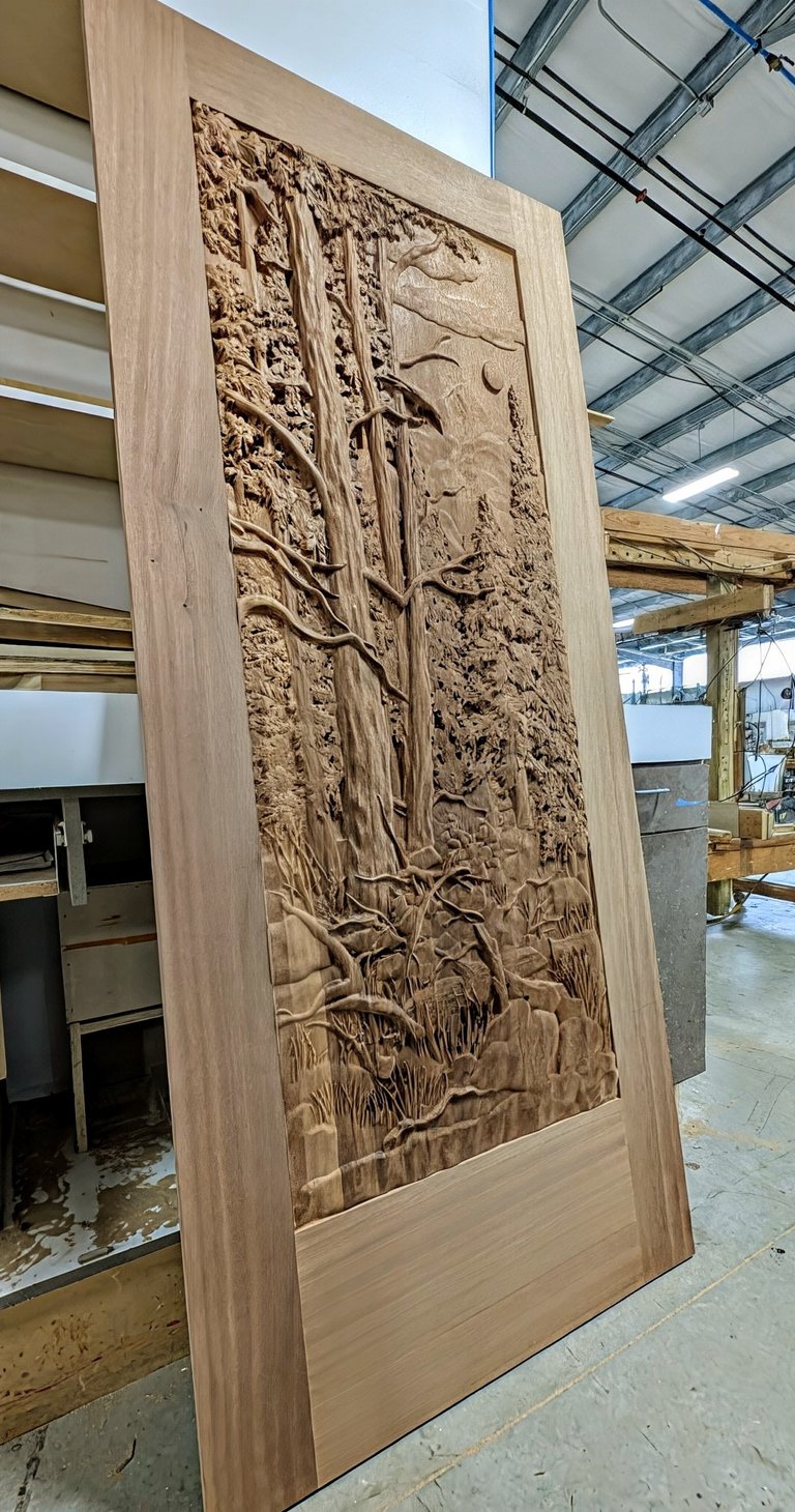 a 3d relief carved wooden door with a large wooden paneled door