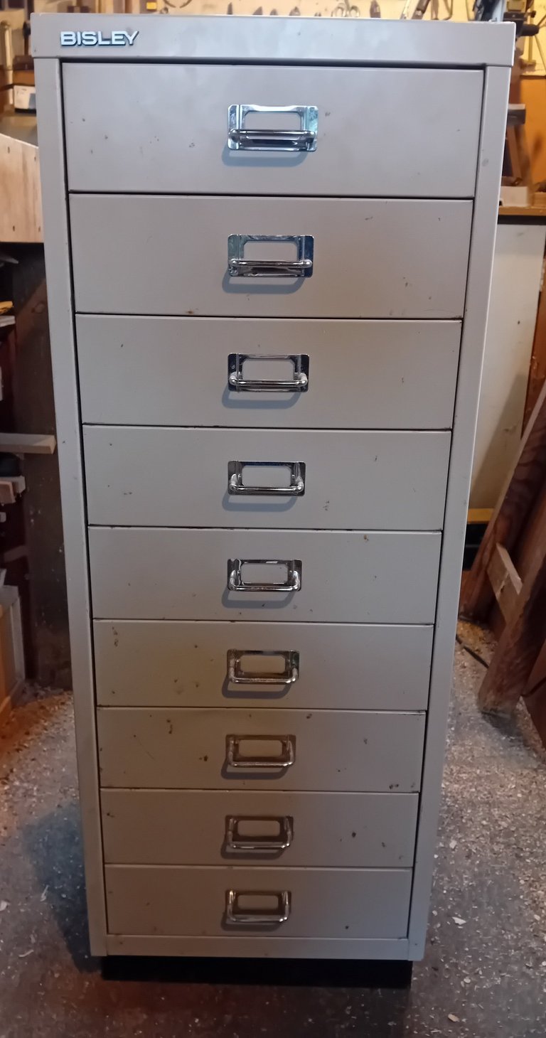 Dull grey metal set of filing drawers with metal handles