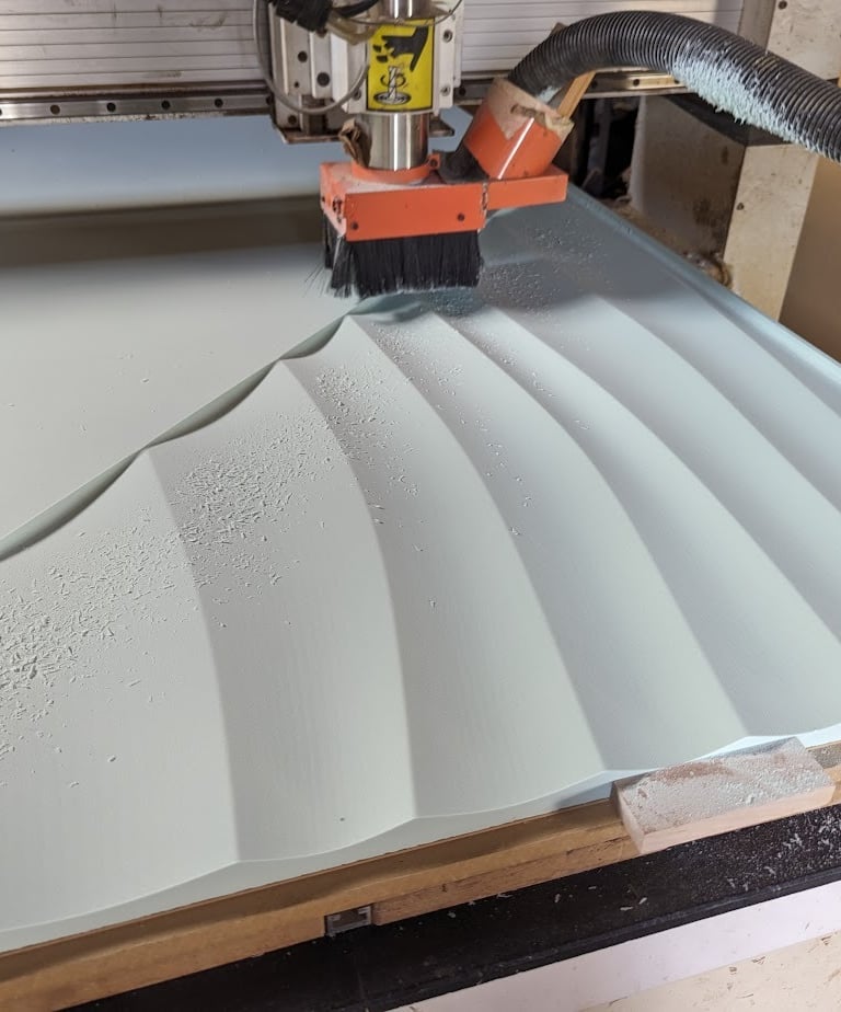a machine is cutting material with a router bit