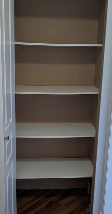Old kitchenware closet, empty: just sagging shelving
