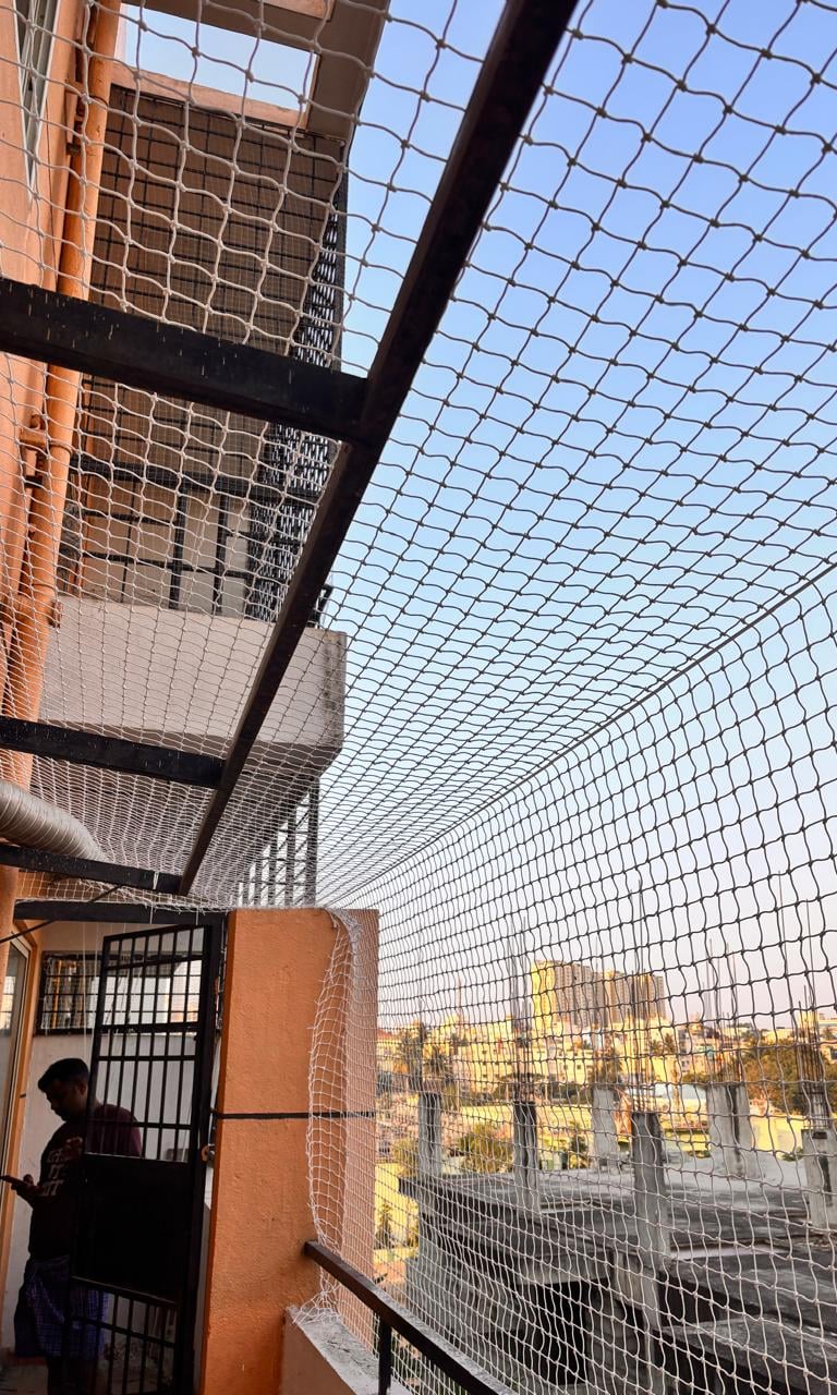 a person standing on a balcony with a view of a city