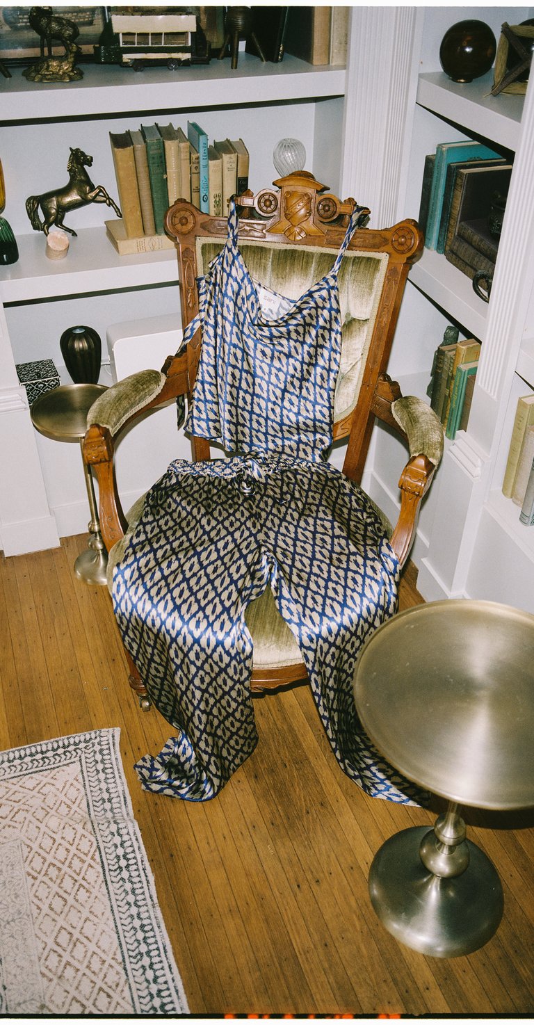 Silk set on vintage chair in home library—visual nod to Sani design background.