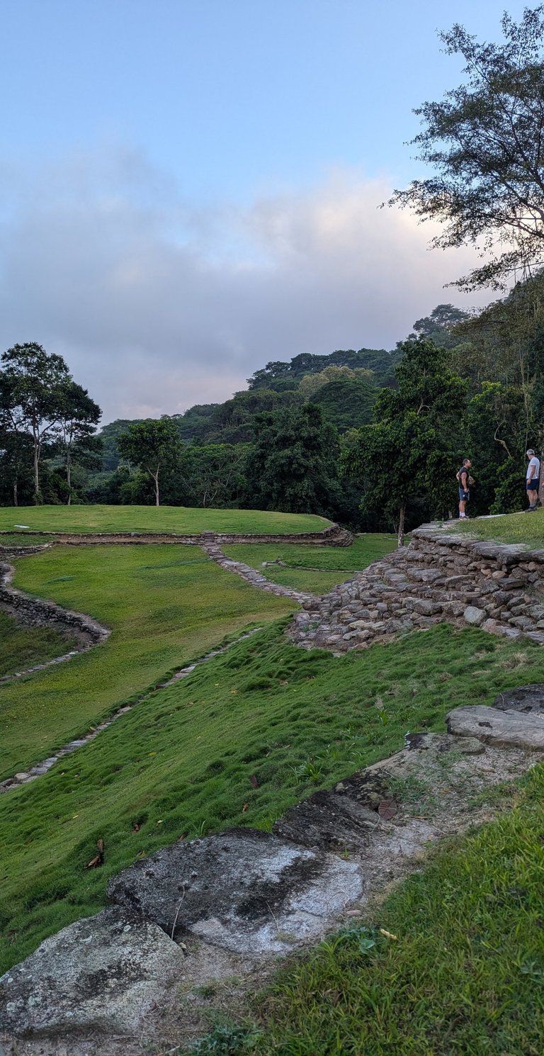 Tourists explore the ancient stone terraces and grassy ruins of Teyuna, the Lost City in Colombia.