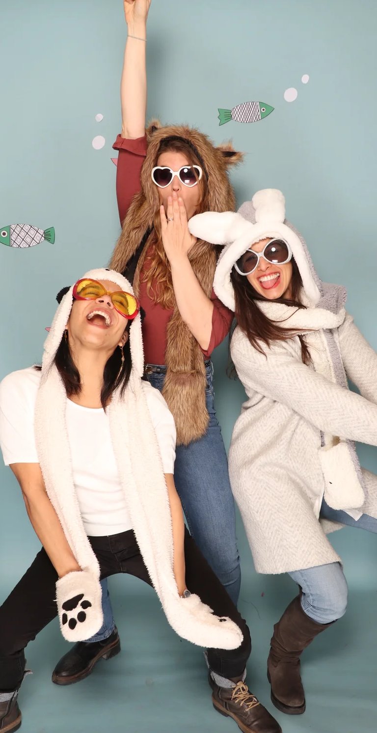 three women in animal print clothing posing for a photo