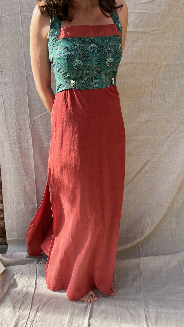 The front of a green and amber maxi dress