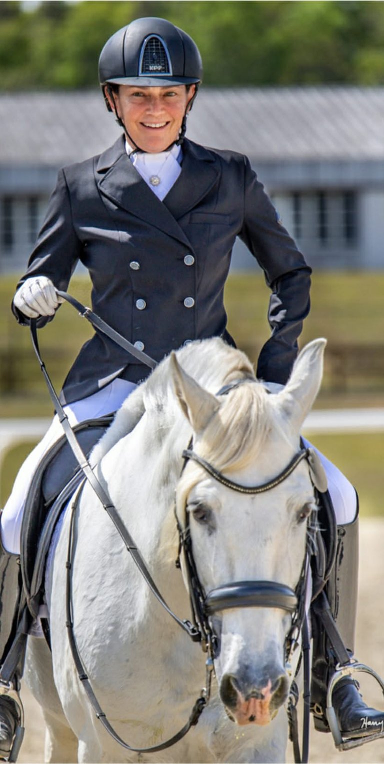 Renee Waters on a grey dressage horse in competition attire