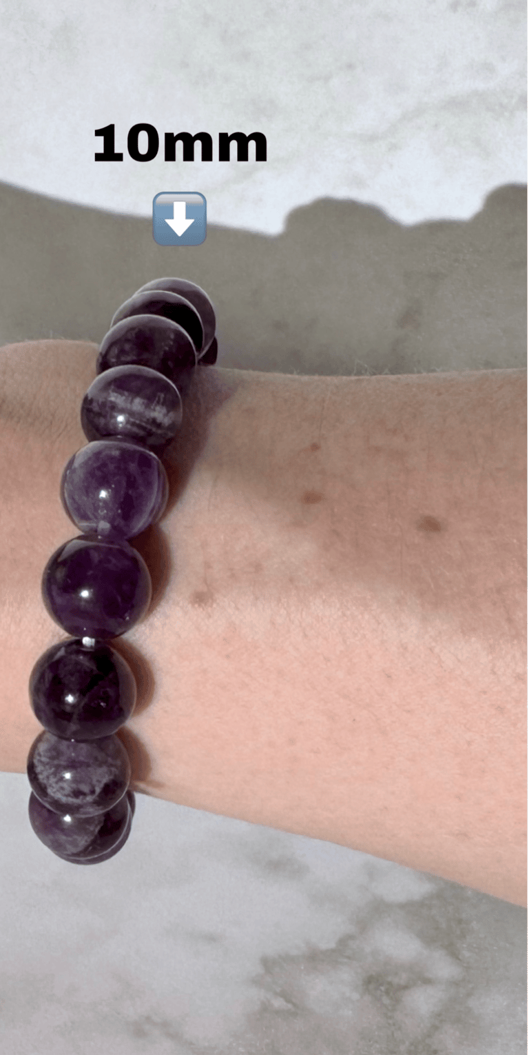 The first half a photo of a wrist with 2 amethyst crystal bracelets on it,this side is the 10mm size