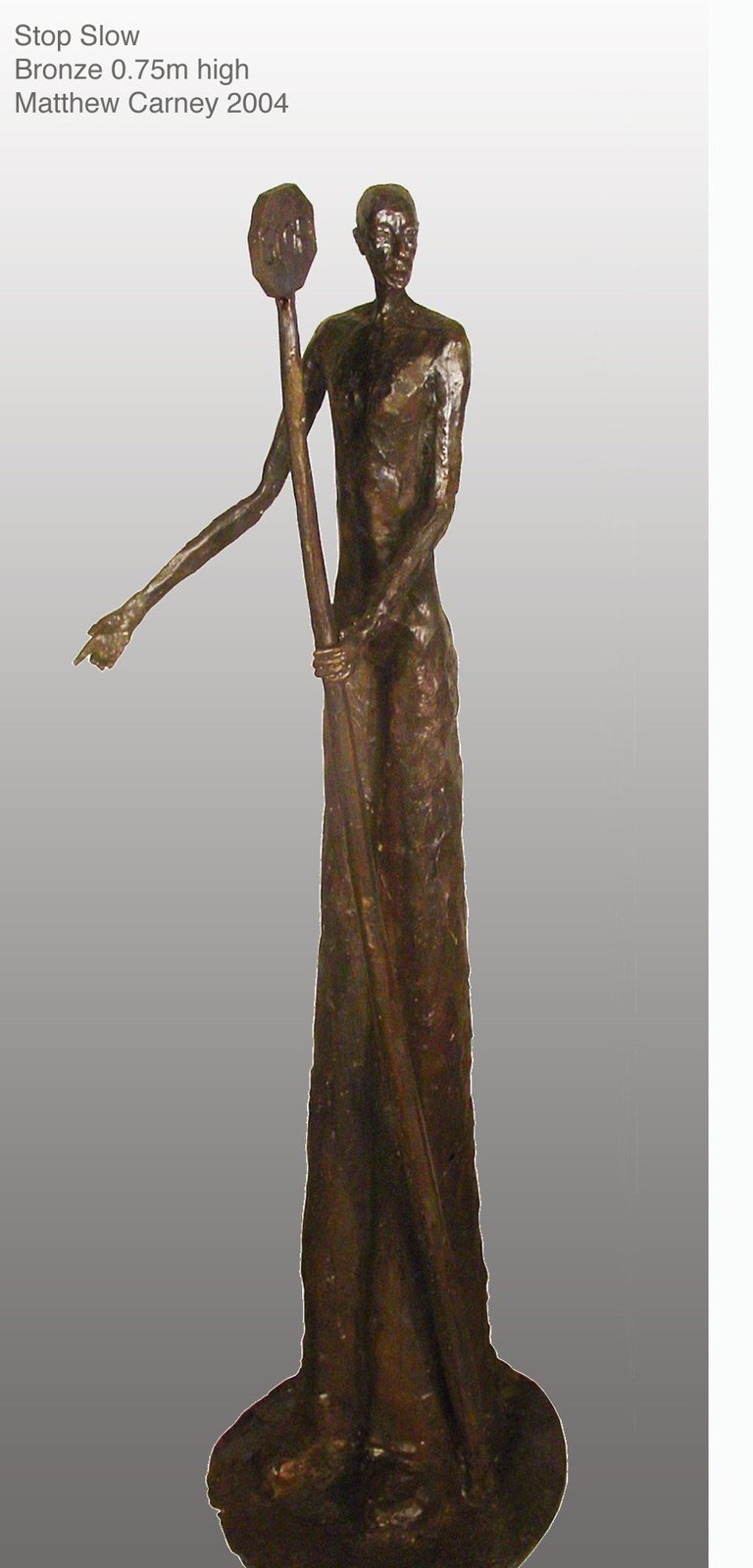 a sculpture of a workman holding a stop/slow sign
