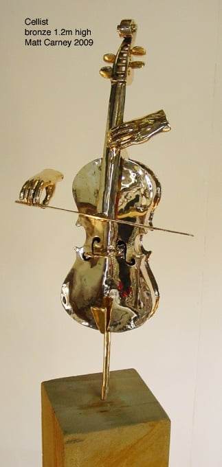 a bronze sculpture of hands playing a cello