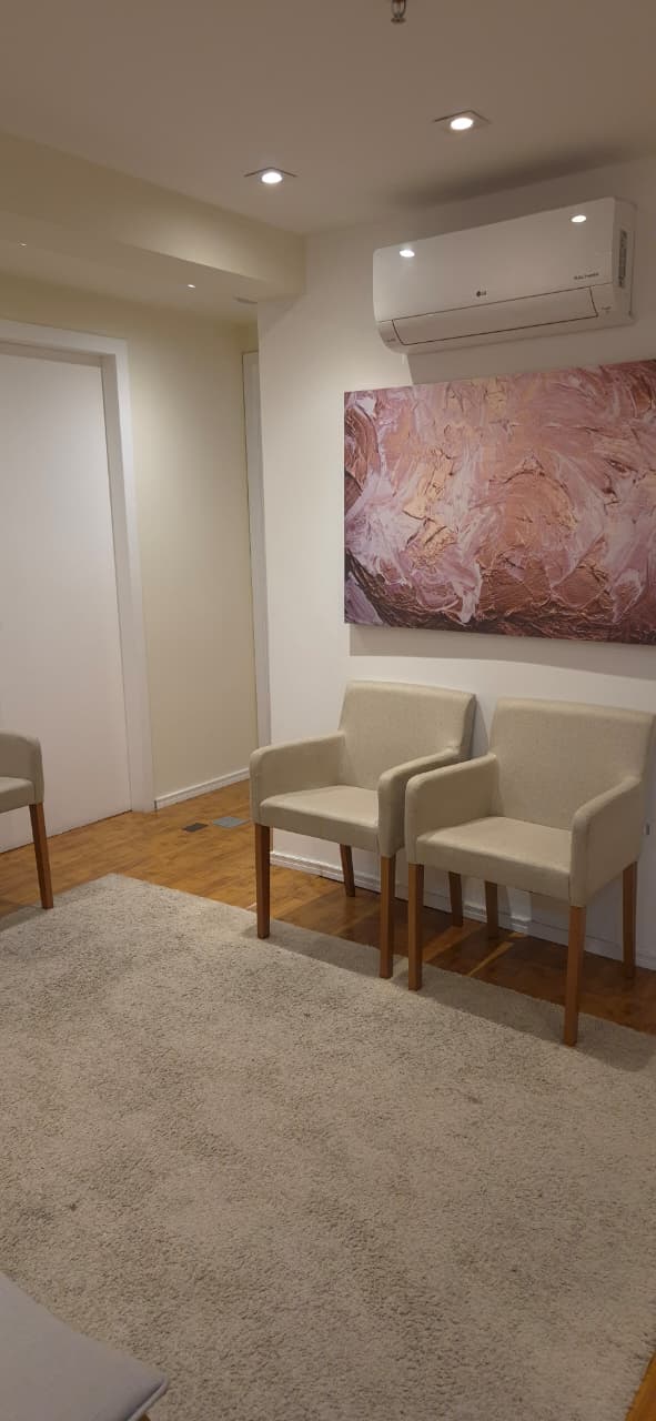 a living room with a couch and chairs