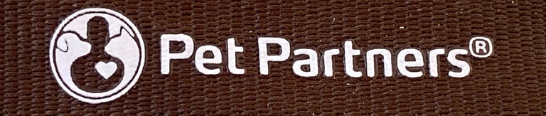 Close up of the Pet Partners brown lanyard, showing the Pet Partners name and logo