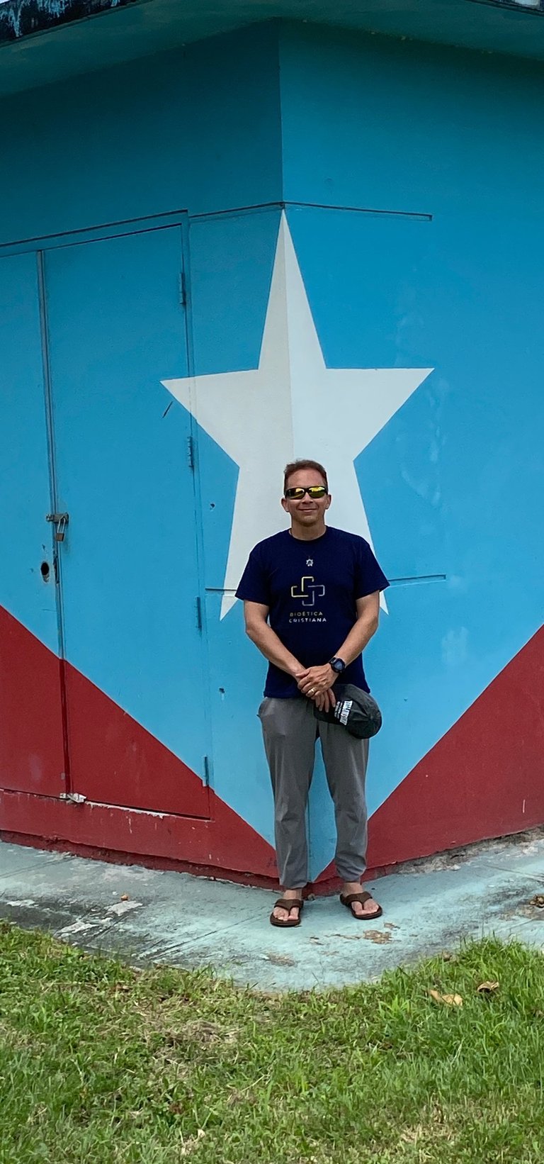 a man standing in front of a building with a large star on it
