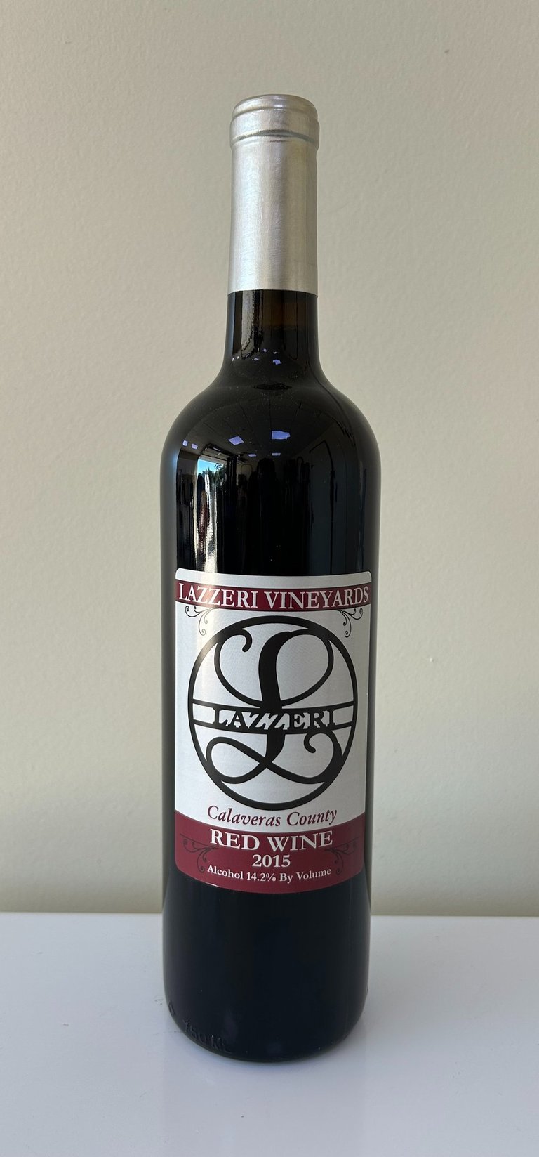 An unopened bottle of wine labeled 2015 Red Blend