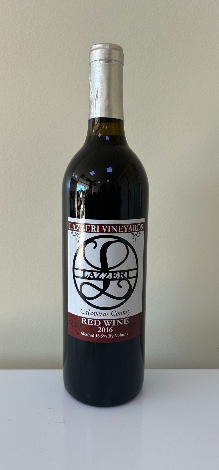 An unopened bottle of wine labeled 2016 Red Blend