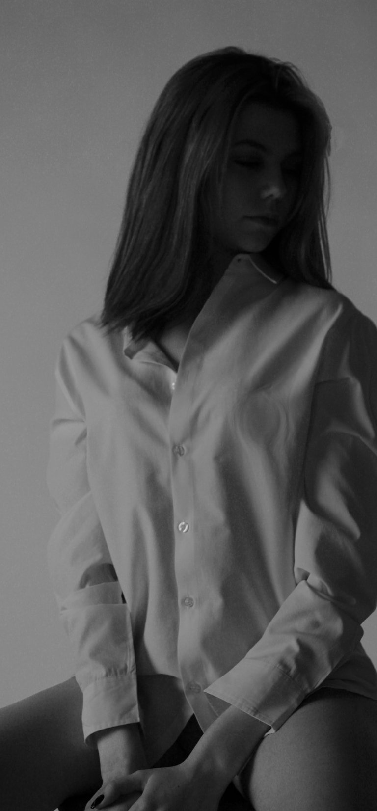 a woman in a white shirt and black pants