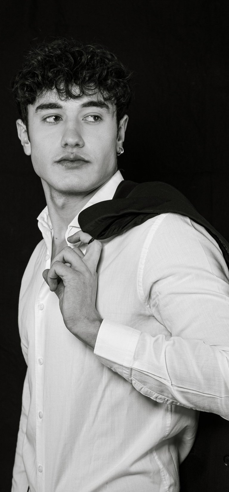 a man in a suit jacket and a white shirt