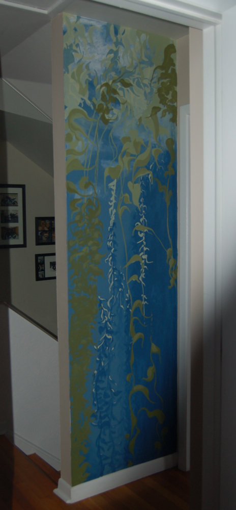 A narrow tall interior wall mural of a swaying peaceful kelp forest in greens and blues by Kathy LaFollett.