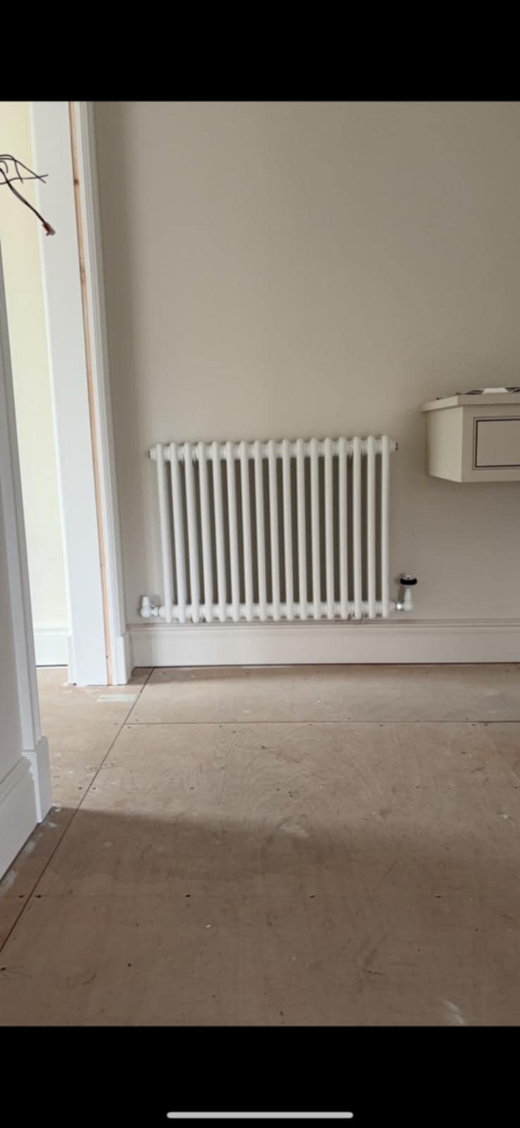 double-panel radiator being leveled and tested by PBP Services in Pershore