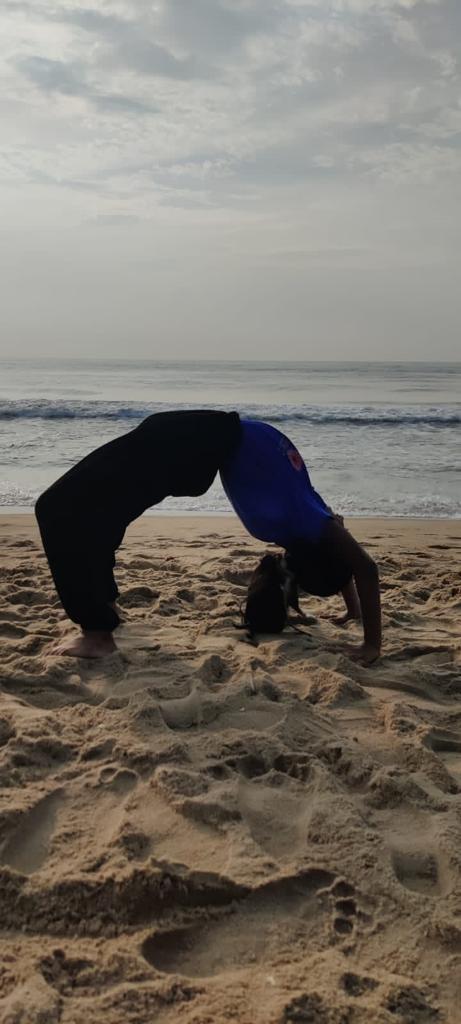 a person doing a handstand on a beach