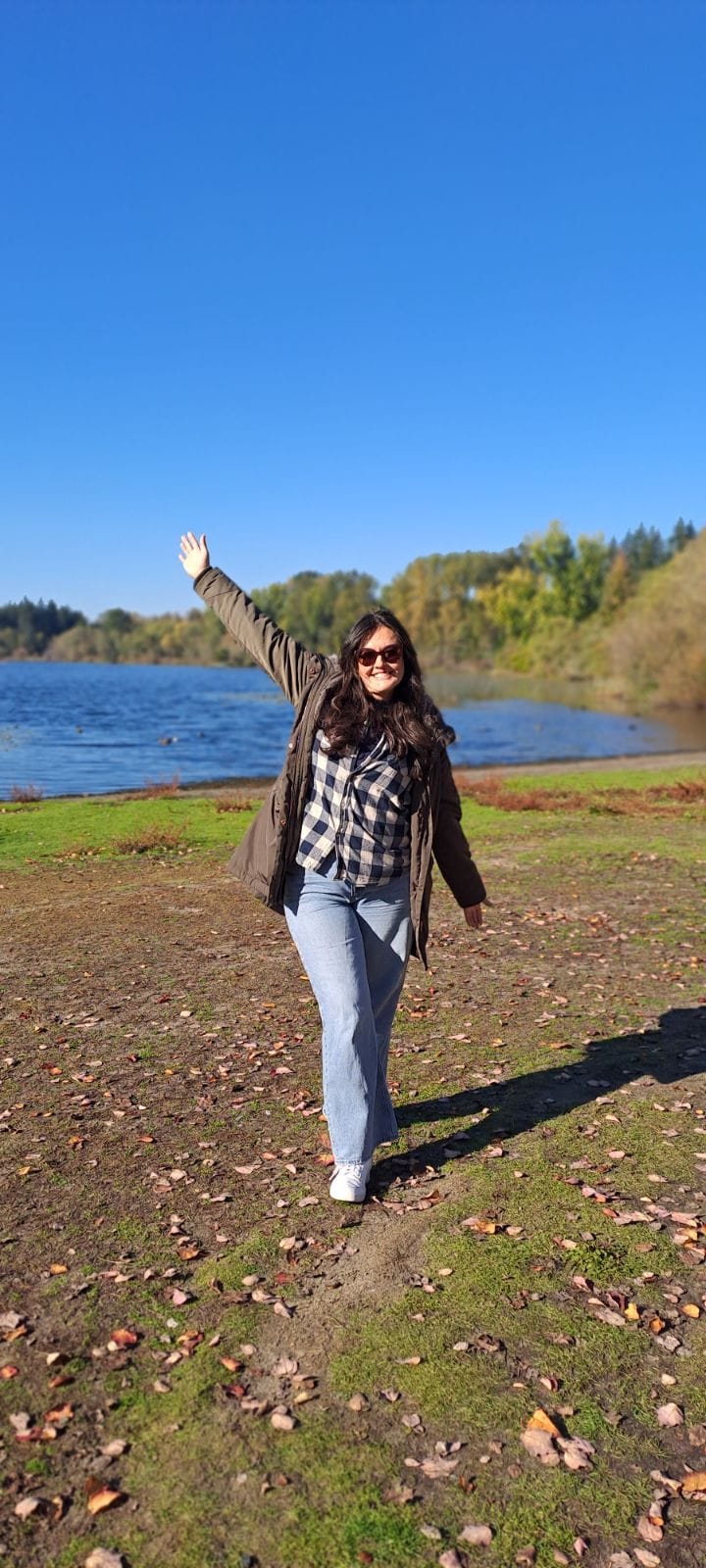 a woman standing in front of a lake