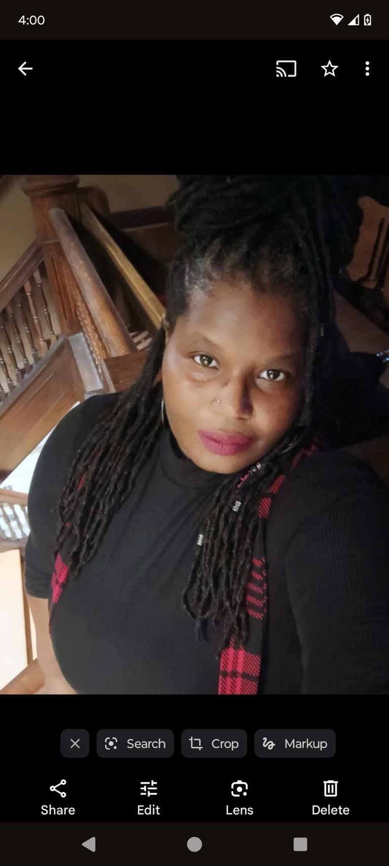 a woman with dreadlocks and a black shirt