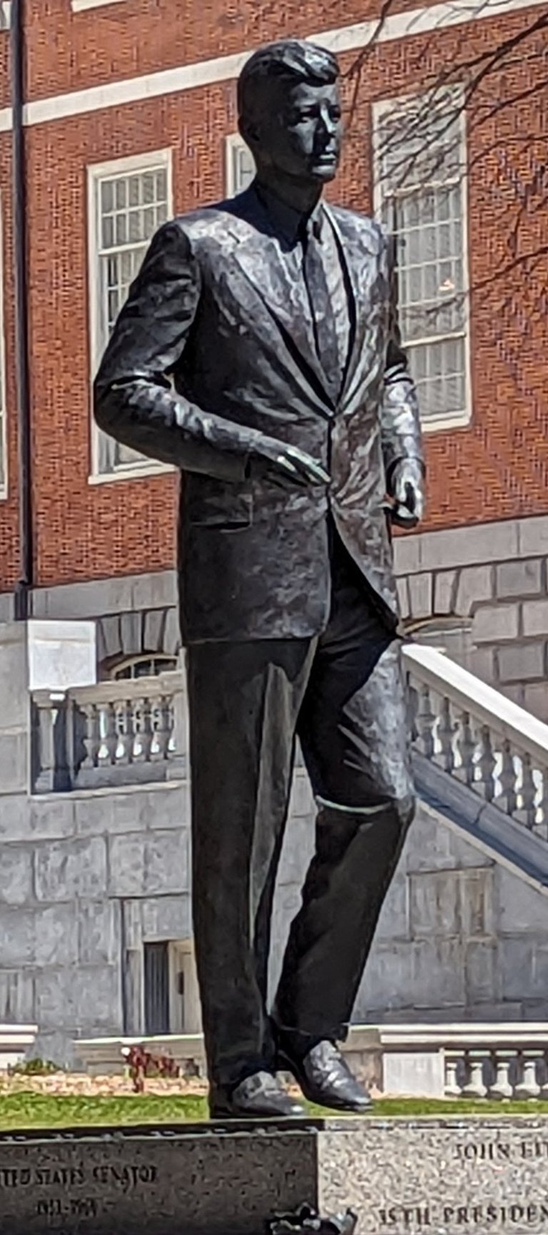 Bronze statue of John F. Kennedy standing outside the Massachusetts State House in Boston.