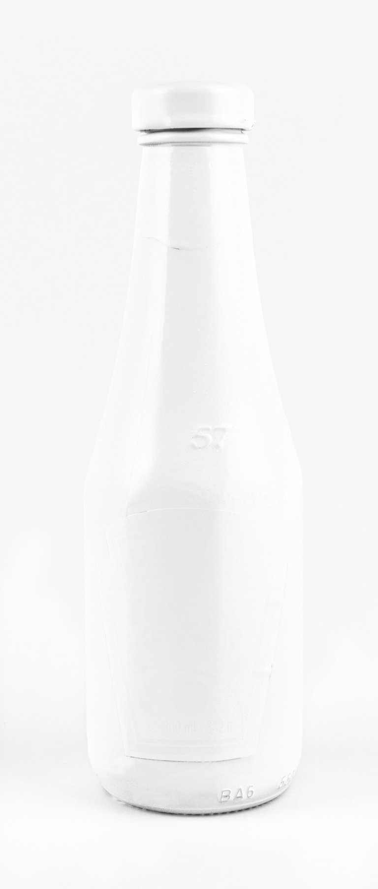 a white bottle of ketchup on a white background