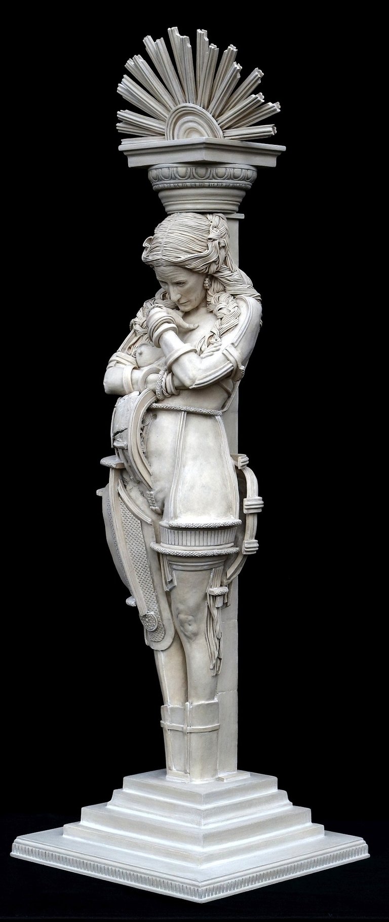 Ceramic sculpture of a woman bound to a column with capital, made by female artist, exploring social expectations of women.