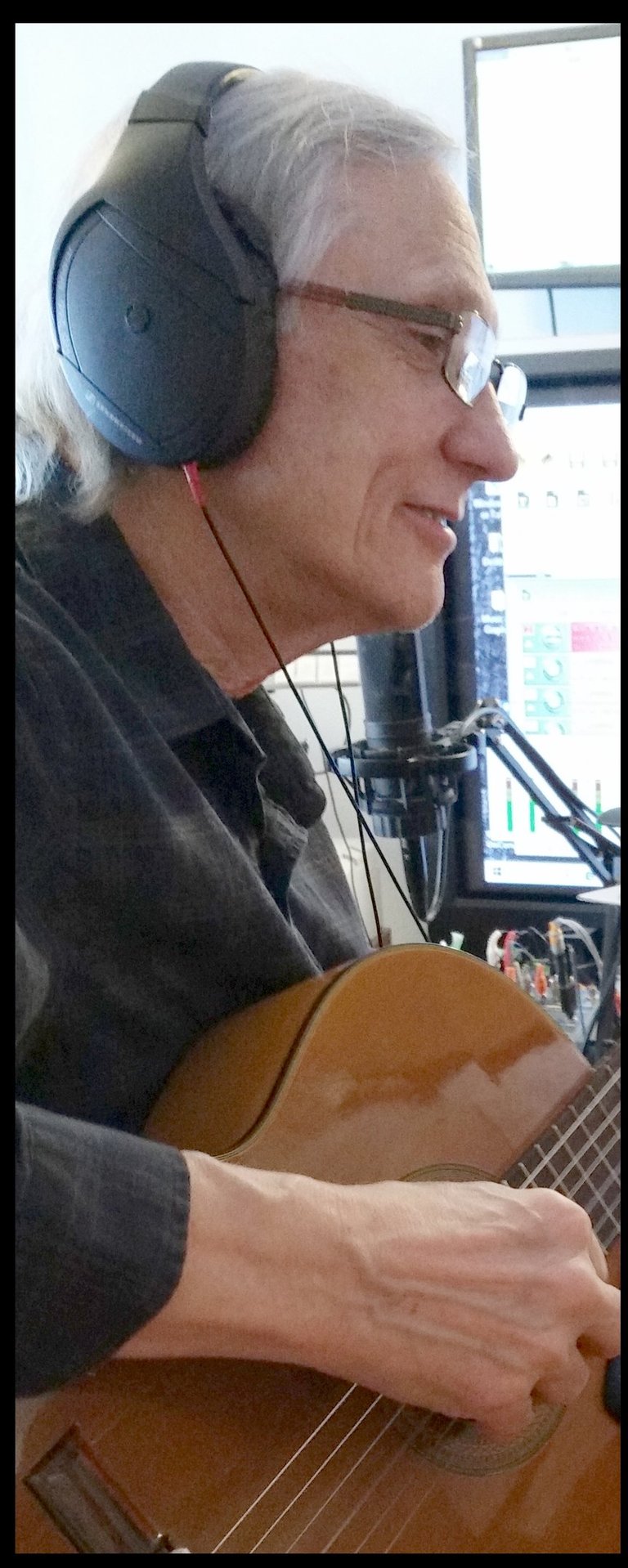 Bob Bushnell playing guitar in a recording studio