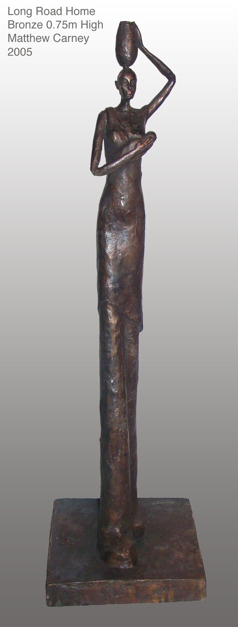 an  elongated sculpture of a woman holding a baby to her breast with a jar of water on her head 