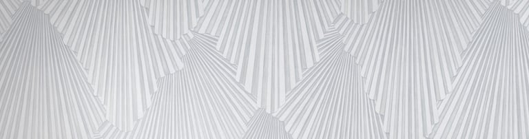 Modern dining room featuring grey geometric fan pattern wallpaper behind a white marble table.