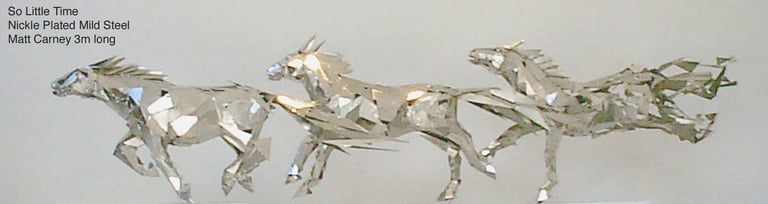 a group of silver horses galloping, with the last becoming pixelated