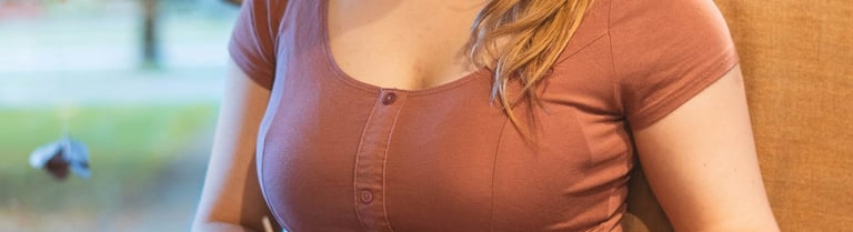 90s style portait picture of a young girl in a coffee shop reading a book in a big armchair 