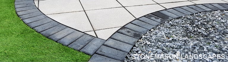 Patio with custom stone circle with aggregates and paving weaving through adventurous garden design
