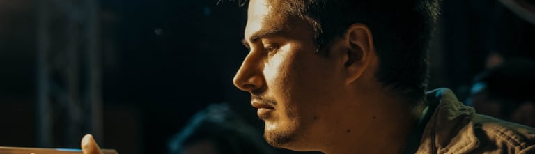 a man sitting at a table with a laptop