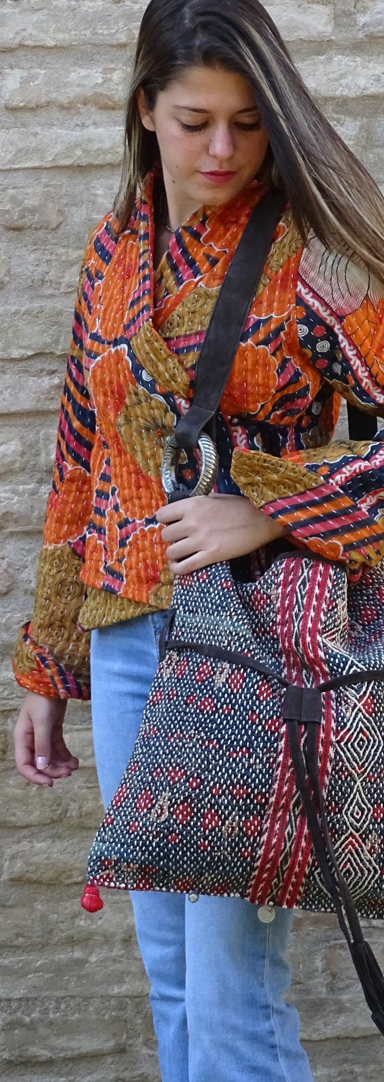 modella che indossa una borsa realizzata con un antico tessuto tribale