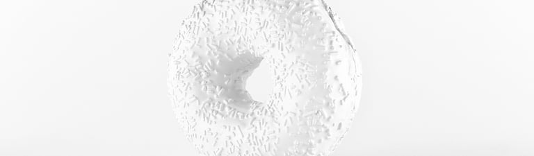 a white sculpture of a large white donut