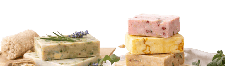 Handmade organic soap bars with natural ingredients like lavender, rosemary, and oats on a black background.