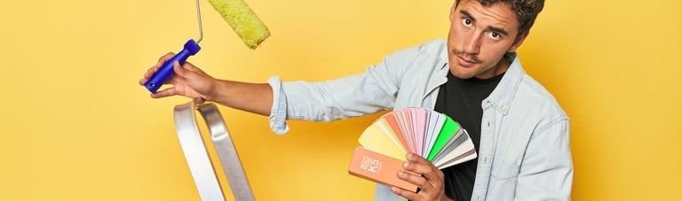 a man holding a paint roller brush and a paint roller