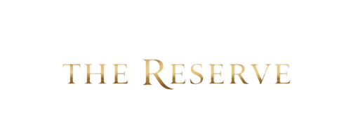 Elegant gold serif typography for The Reserve logo on a solid black background.
